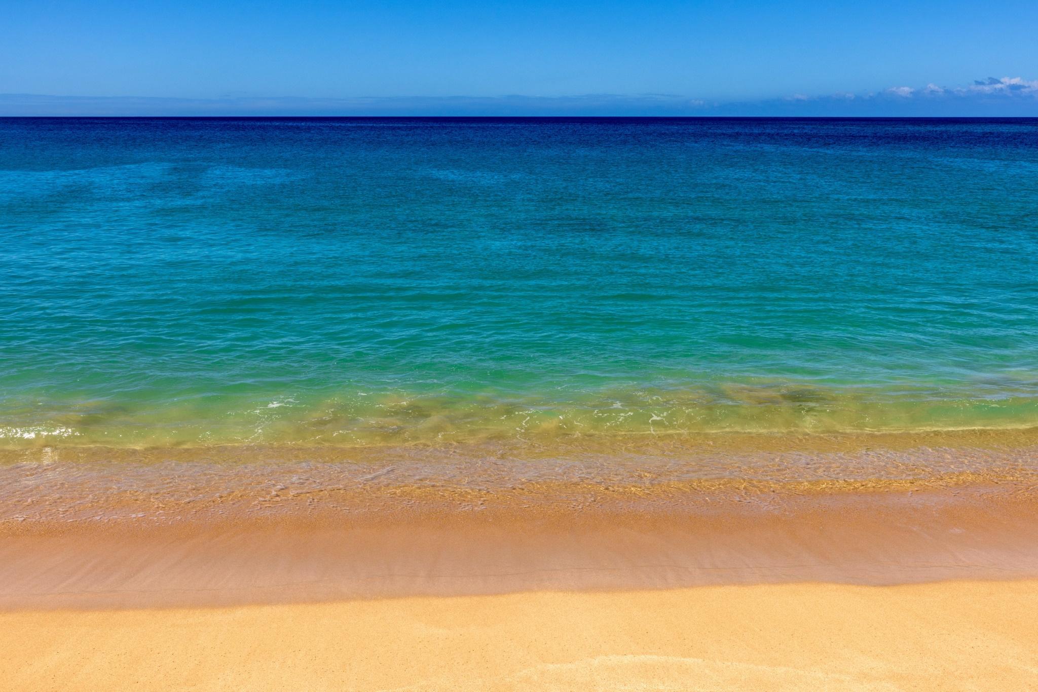 A Hawaiian beach in many layers of blue and tan.