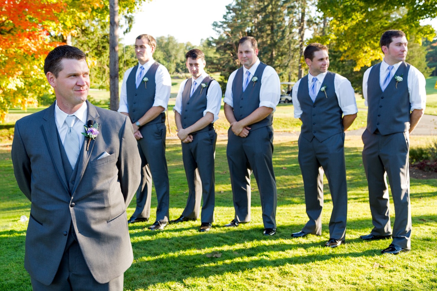 A groom and his groomsmen looking to the right.
