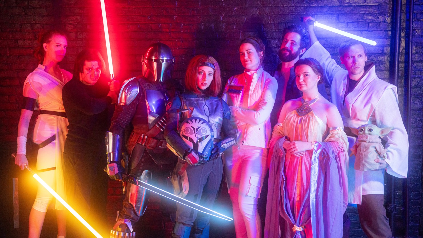 Eight Star Wars cosplayers in various poses.