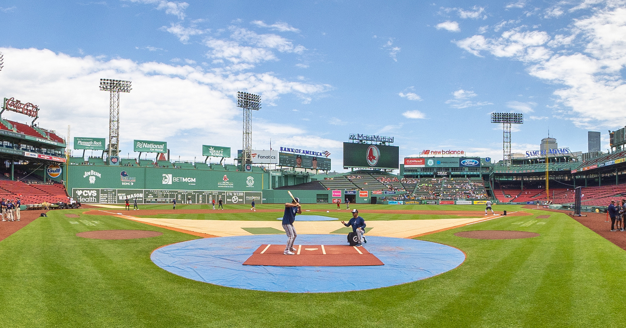 A wide angle photo of the Braves during batting practice at Fenway Park.