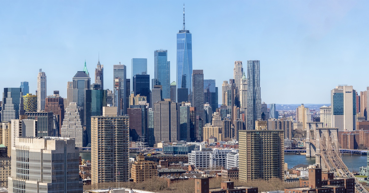 The Manhattan skyline at 1pm. The sky is clear blue.