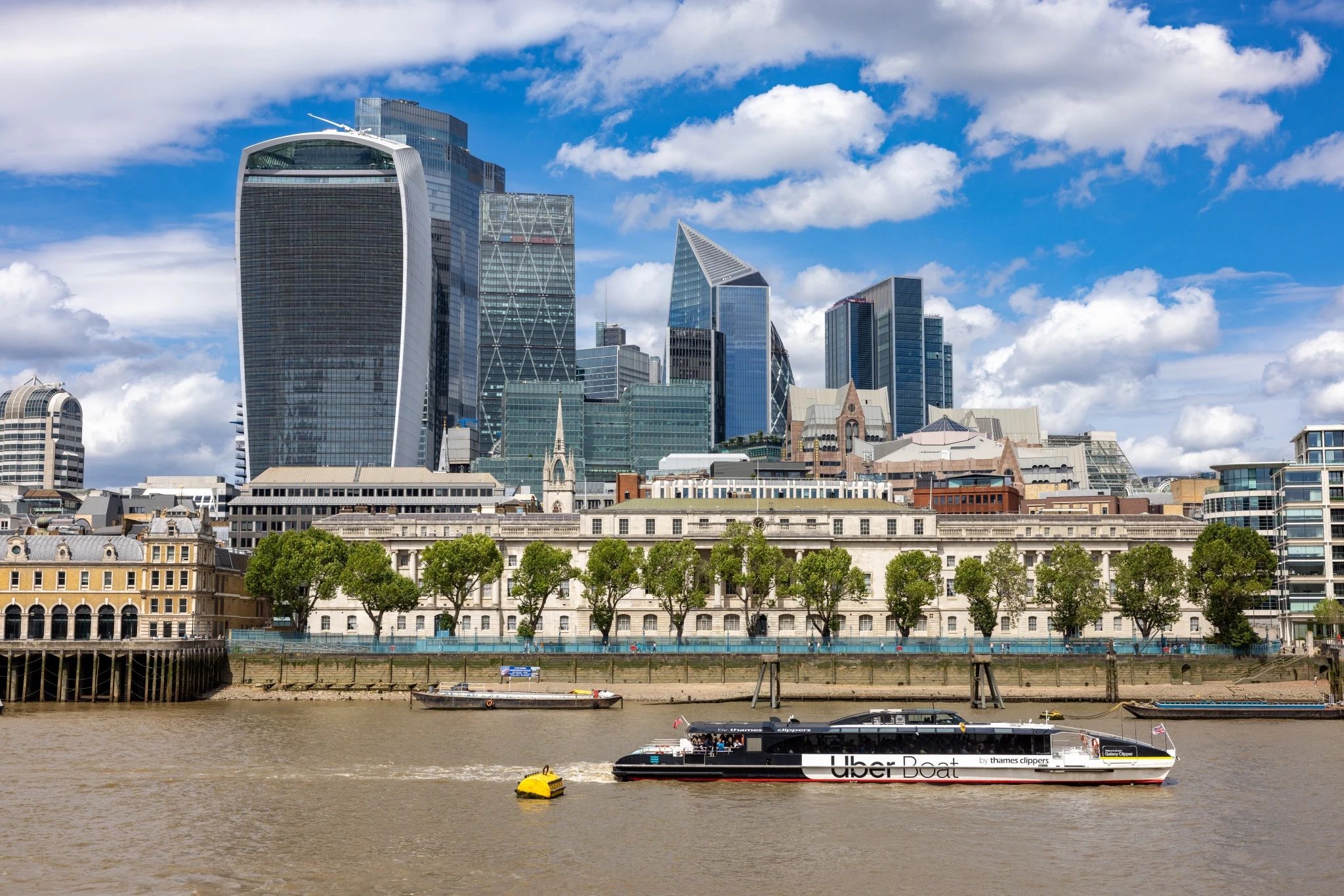 A section of the London skyline under a partly cloudy sky.