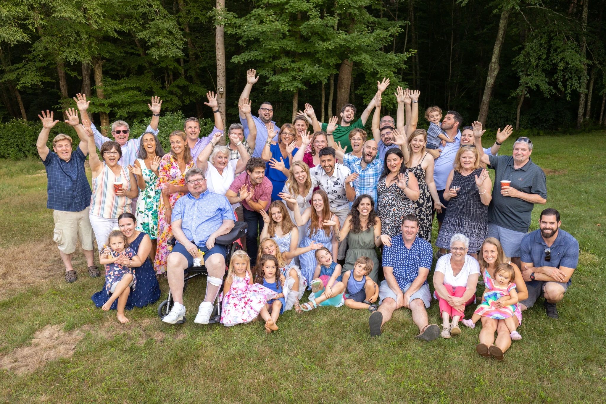 A happy group of people waving their arms in celebration.