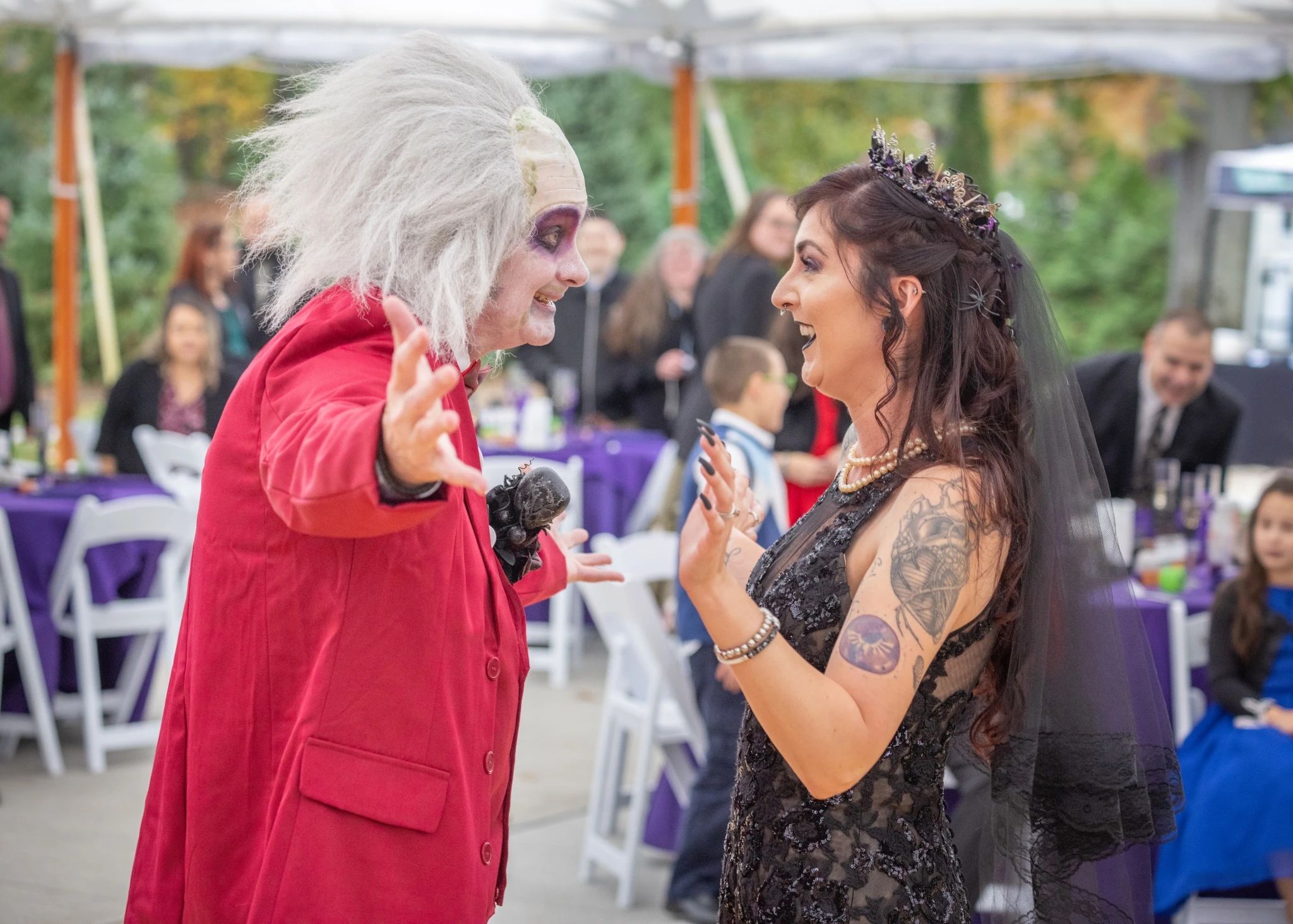 Two people in costume dancing and celebrating.