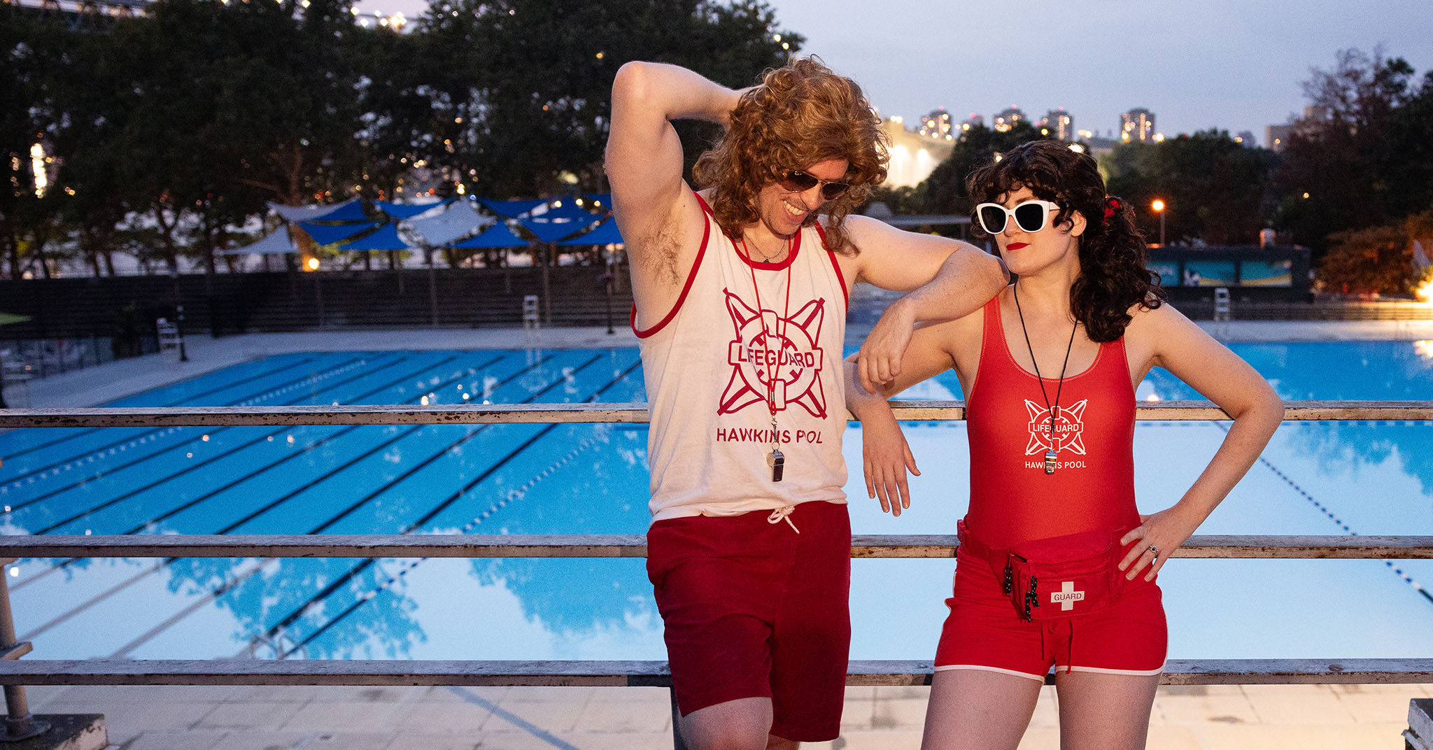 Two people cosplaying as lifeguards from Stranger Things.